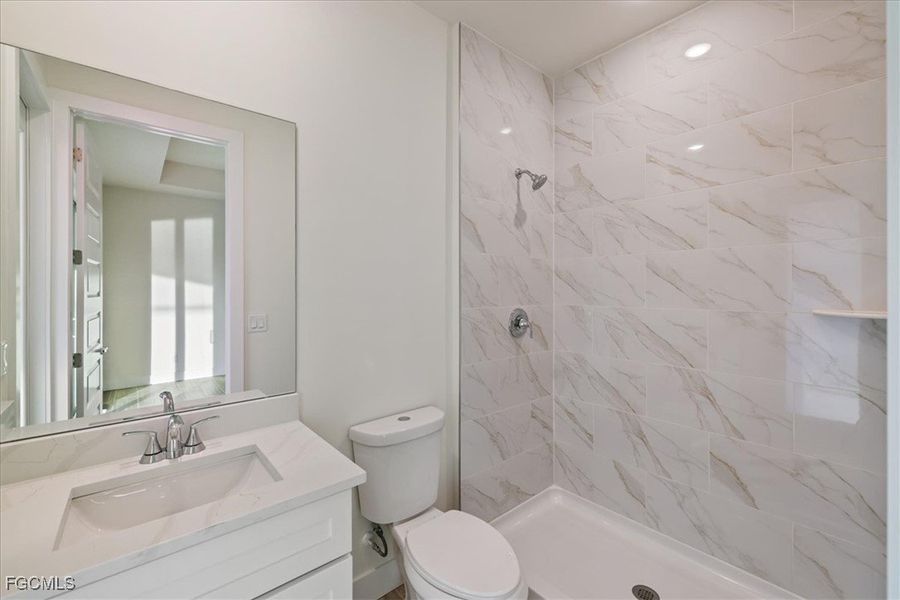 Bathroom featuring a stall shower and vanity