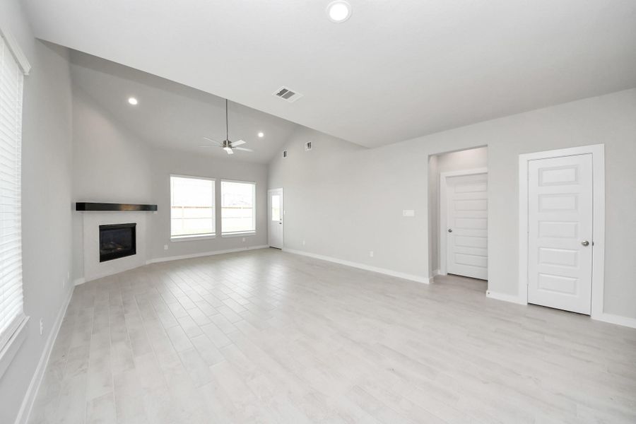 Welcome family and guests to your charming living room! With its high ceilings, recessed lighting, ceiling fan, custom paint, beautiful flooring, and large windows that let in abundant natural light, this room is perfect for gatherings. Sample photo of completed home with similar floor plan. Actual colors and selections may vary. Welcome family and guests to your charming living room! With its high ceilings, recessed lighting, ceiling fan, custom paint, beautiful flooring, and large windows that let in abundant natural light, this room is perfect for gatherings. Sample photo of completed home with similar floor plan. Actual colors and selections may vary.