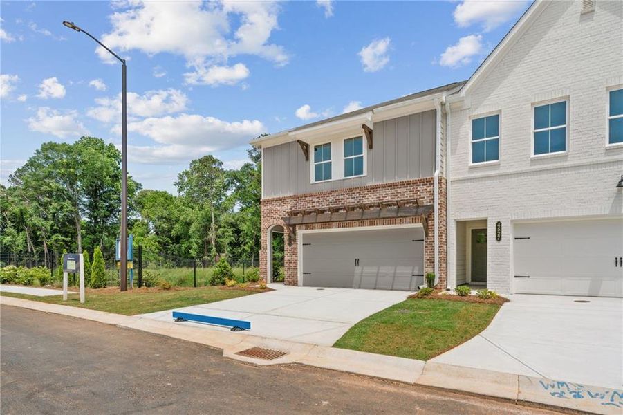 Front exterior of a new home in Wilkins Walk, Mableton, GA, highlighting curb appeal (Image 2). Front exterior of a new home in Wilkins Walk, Mableton, GA, highlighting curb appeal (Image 2).