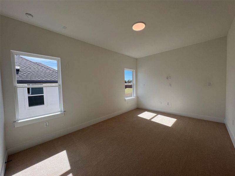 Carpeted spare room with baseboards