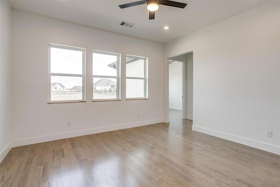 Unfurnished room with recessed lighting, visible vents, ceiling fan, light wood-type flooring, and baseboards