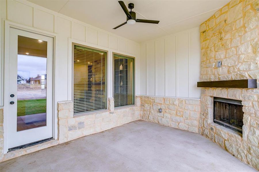 View of patio / terrace featuring ceiling fan and an outdoor stone fireplace