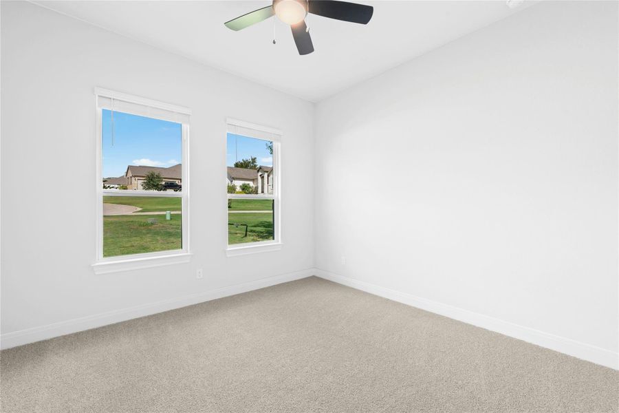 Spare room featuring carpet floors and ceiling fan Spare room featuring carpet floors and ceiling fan
