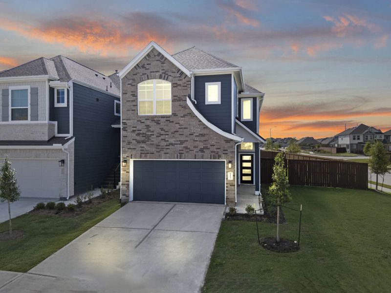 Front exterior of a new home in Meridiana, Manvel, TX, highlighting curb appeal (Image 20).