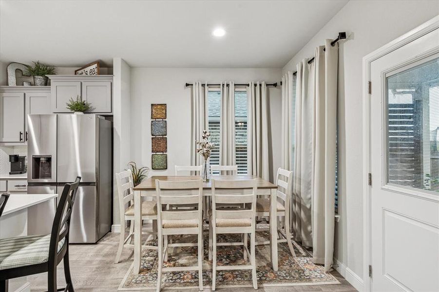 Dining area with light wood finished floors, and recessed lighting Dining area with light wood finished floors, and recessed lighting