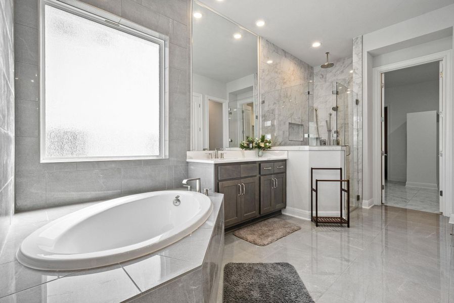 Bathroom featuring a bath, a stall shower, vanity, and recessed lighting