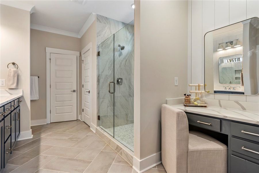This primary bathroom features a spacious glass-en