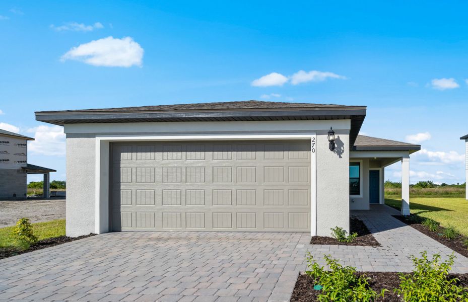 Front exterior of a new home in Whispering Lakes, Lehigh Acres, FL, highlighting curb appeal (Image 2). Front exterior of a new home in Whispering Lakes, Lehigh Acres, FL, highlighting curb appeal (Image 2).