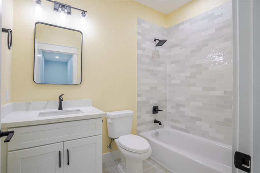 Gorgeous tiled bath and soft coastal color enhance the bath experience!