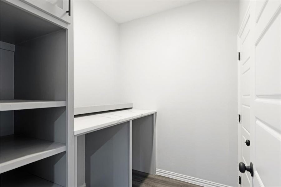 Walk in closet featuring dark wood-style flooring