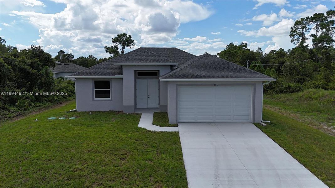 Front exterior of a new home in , Lehigh Acres, FL, highlighting curb appeal (Image 20). Front exterior of a new home in , Lehigh Acres, FL, highlighting curb appeal (Image 20).