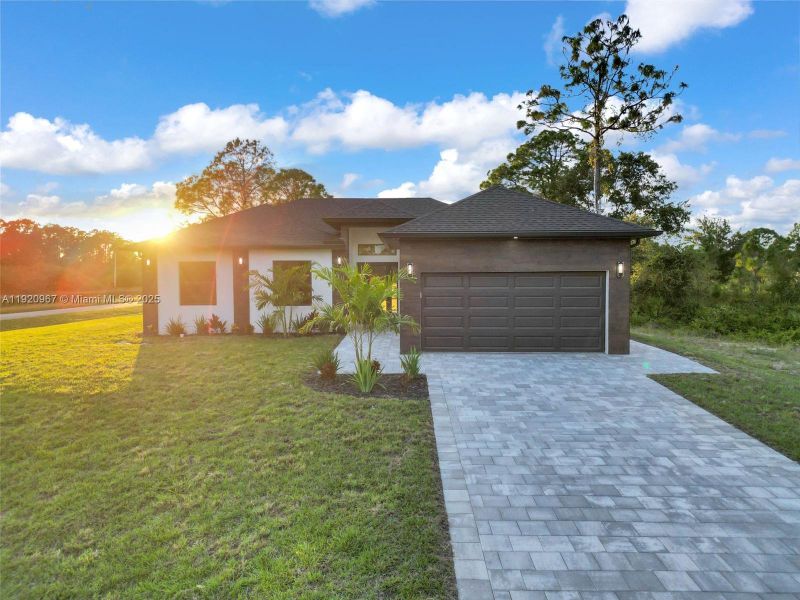 Front exterior of a new home in , Lehigh Acres, FL, highlighting curb appeal (Image 19).