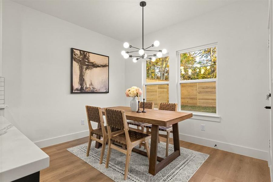 Dining space featuring light wood-style flooring and a chandelier