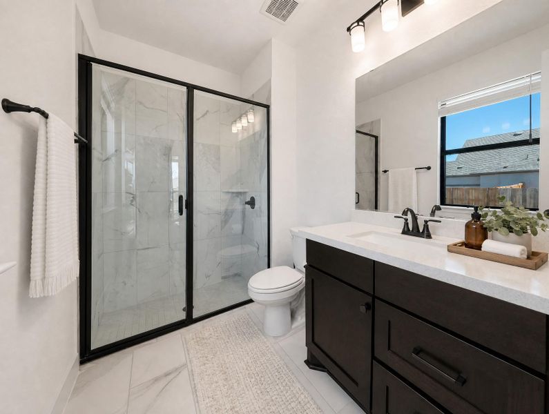 A well-appointed bathroom features a spacious walk-in shower and a modern vanity. A well-appointed bathroom features a spacious walk-in shower and a modern vanity.