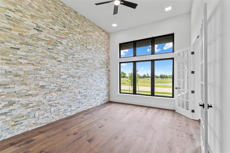 Spare room with french doors, ceiling fan, and hardwood / wood-style floors