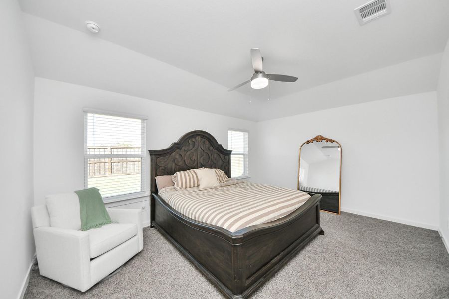 The primary bedroom is full of natural light, high ceilings and has TONS of extra space.
