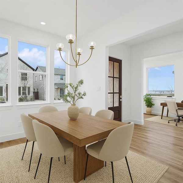 Dining space featuring a chandelier, light wood finished floors, and recessed lighting virtually staged