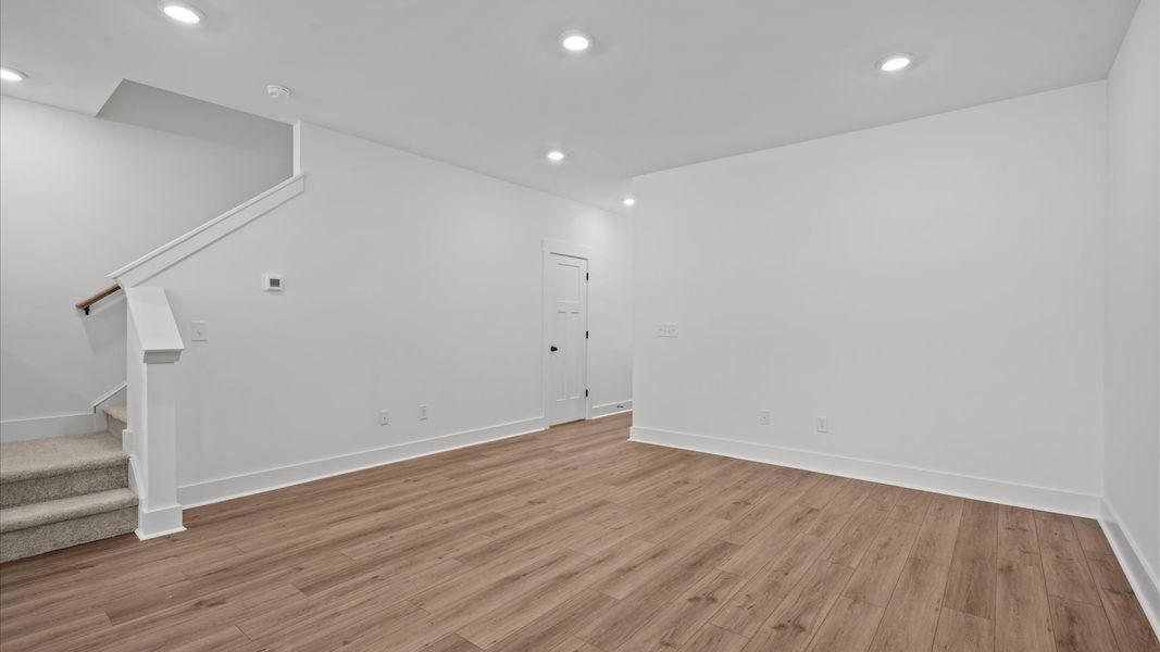 Tasteful family room with high ceilings, modern fixtures, and a warm, inviting feel