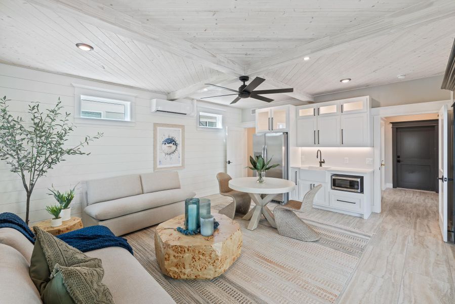 Living area with a wall mounted AC, a ceiling fan, a wood ceiling with exposed beams, recessed lighting, and light wood-type flooring Living area with a wall mounted AC, a ceiling fan, a wood ceiling with exposed beams, recessed lighting, and light wood-type flooring