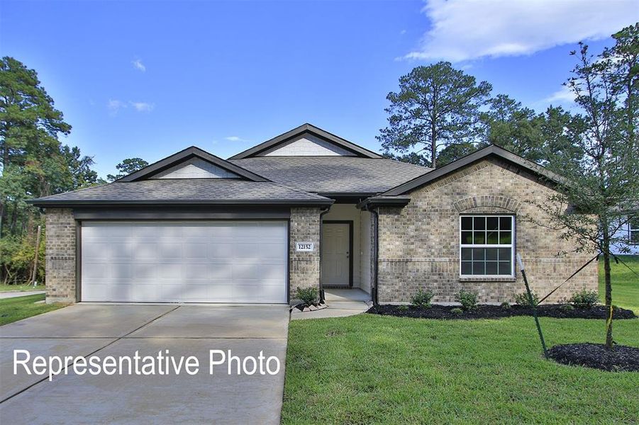 View of front of house with a front yard and a garage