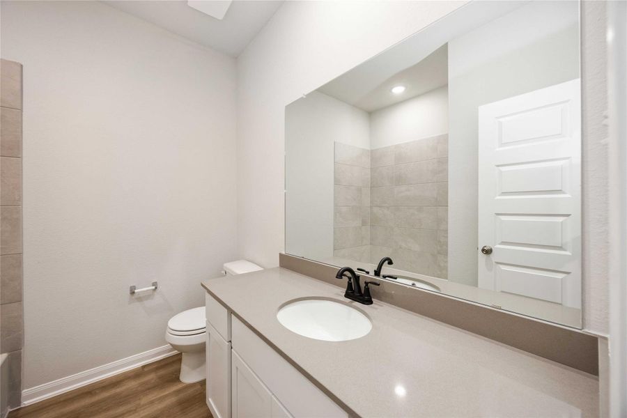 The full secondary bathroom features extended cabinet space and modern black hardware. The full secondary bathroom features extended cabinet space and modern black hardware.