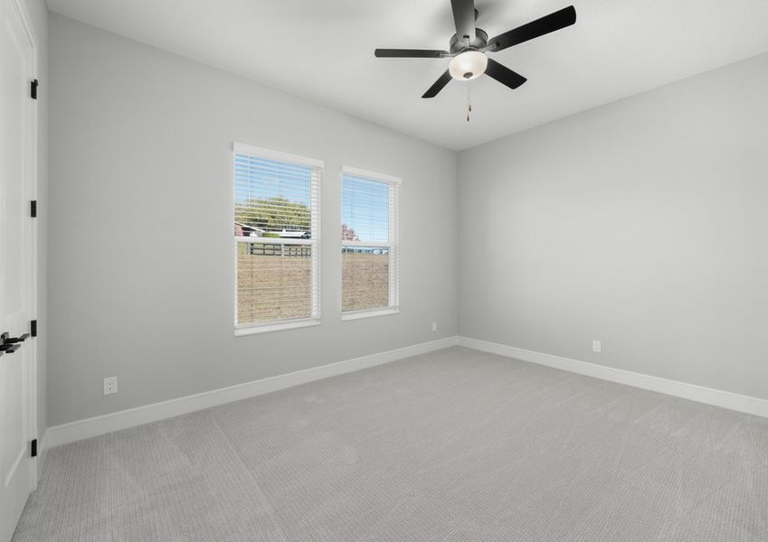 Secondary bedroom with a ceiling fan.