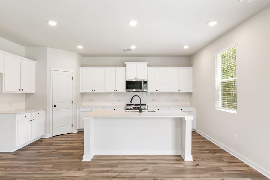 A kitchen with white cabinets. A kitchen with white cabinets.
