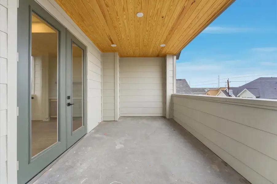 Doors open to the rooftop deck.