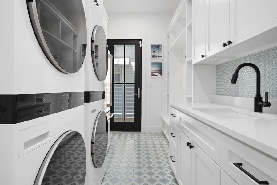 Laundry room with 2 sets of washer/dryers and fullsize refrigerator Laundry room with 2 sets of washer/dryers and fullsize refrigerator