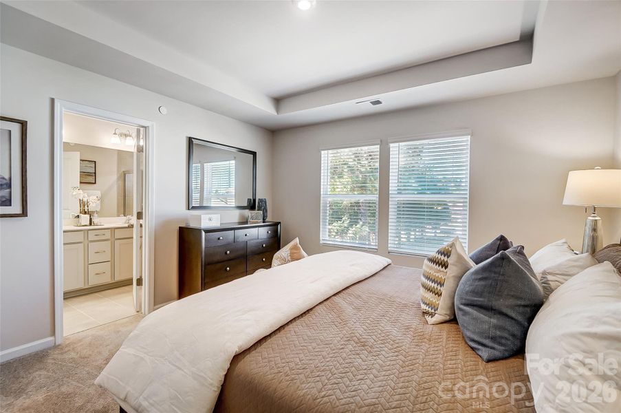 Primary Suite with View to Primary Bathroom-Photo Similar to Subject Property