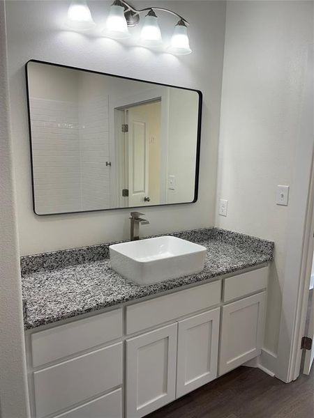 Bathroom with hardwood / wood-style floors and vanity