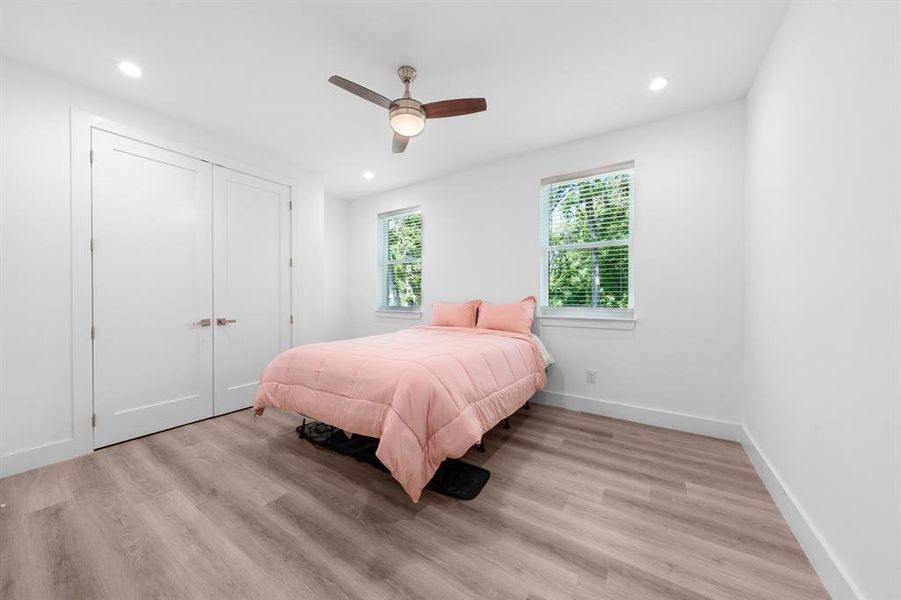 Bedroom with light wood-style flooring, recessed lighting, a ceiling fan, and a closet Bedroom with light wood-style flooring, recessed lighting, a ceiling fan, and a closet