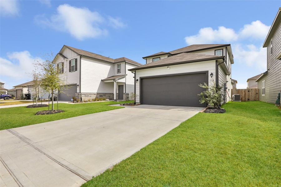 Front exterior of a new home in Barrett Crossing, Crosby, TX, highlighting curb appeal (Image 24).