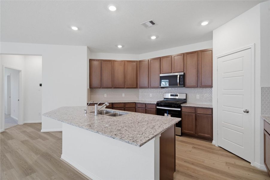 This spacious kitchen has it all—ample storage, generous counter space, and a layout that truly makes it the heart of the home. This spacious kitchen has it all—ample storage, generous counter space, and a layout that truly makes it the heart of the home.