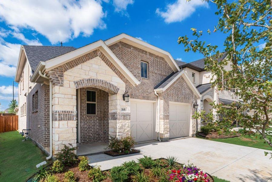 Front exterior of a new home in Spiritas Ranch, Little Elm, TX, highlighting curb appeal (Image 18). Front exterior of a new home in Spiritas Ranch, Little Elm, TX, highlighting curb appeal (Image 18).