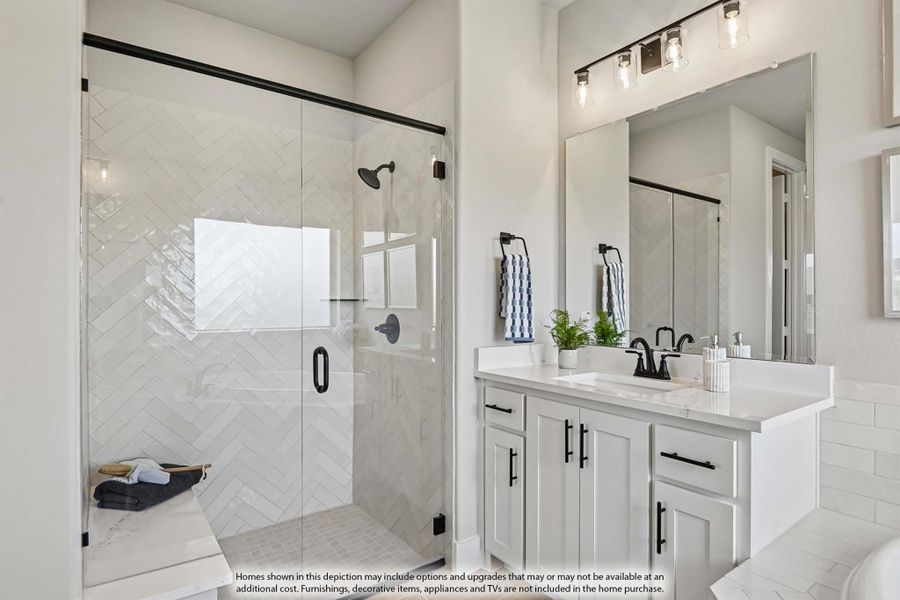 Bathroom with glass walk-in shower, herringbone tile, white vanity, and black fixtures Bathroom with glass walk-in shower, herringbone tile, white vanity, and black fixtures