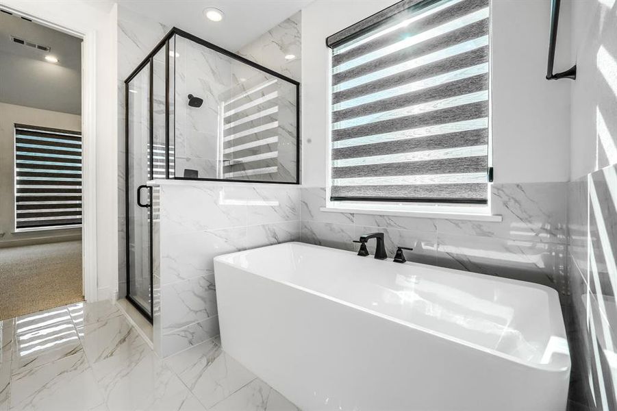 Full bath featuring a marble finish shower, recessed lighting, marble finish floor, and a freestanding tub