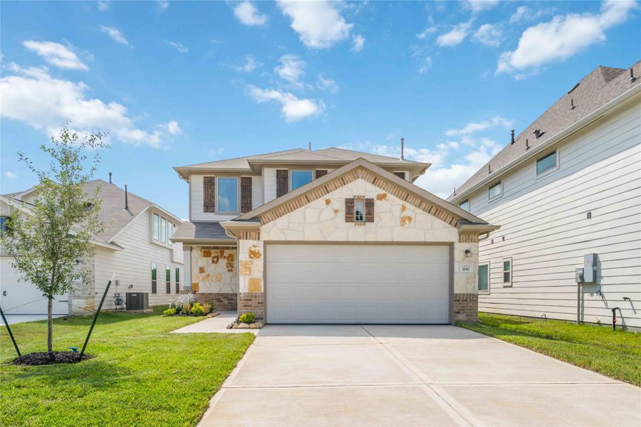 Front exterior of a new home in The Landing, New Caney, TX, highlighting curb appeal (Image 2). Front exterior of a new home in The Landing, New Caney, TX, highlighting curb appeal (Image 2).
