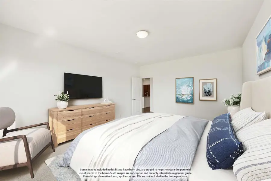 Bedroom with queen bed, wood dresser, wall-mounted TV, and ensuite bathroom doorway visible