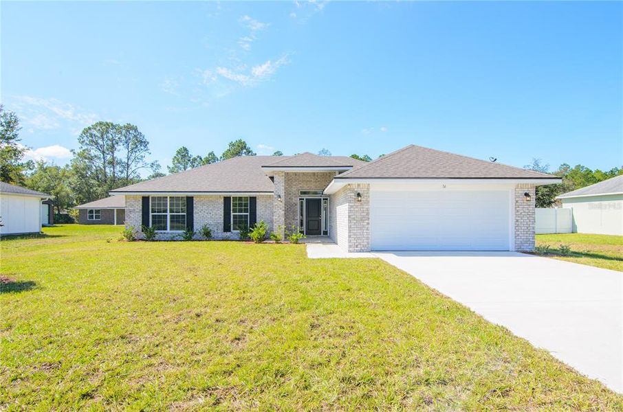Front exterior of a new home in Palm Coast, Palm Coast, FL, highlighting curb appeal (Image 2). Front exterior of a new home in Palm Coast, Palm Coast, FL, highlighting curb appeal (Image 2).