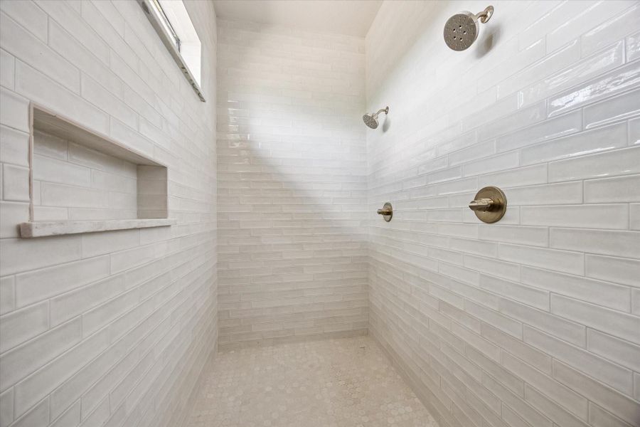 Primary shower with dual shower heads.