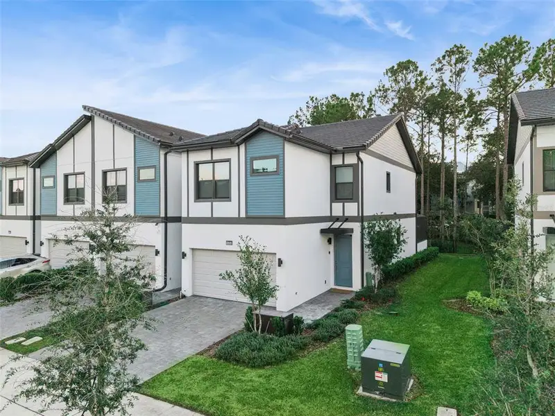 Front exterior of a new home in Paradiso Grande, Orlando, FL, highlighting curb appeal (Image 1).