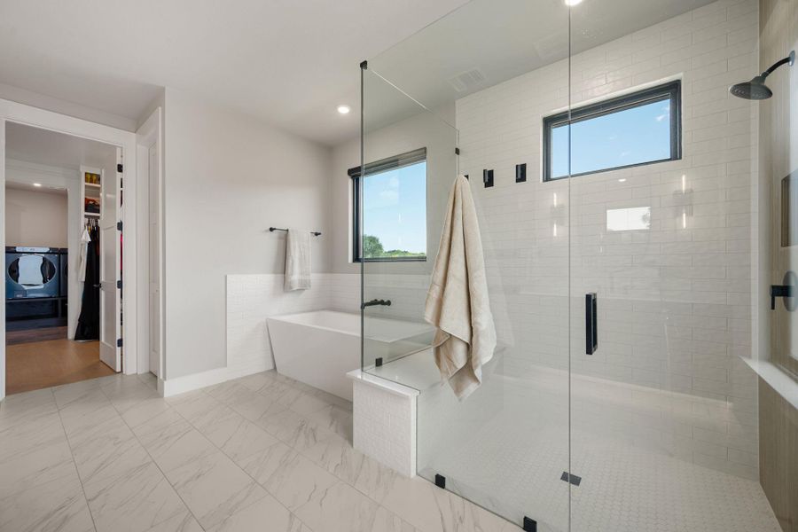 A freestanding tub and a spacious walk-in shower highlight this modern primary bathroom.
