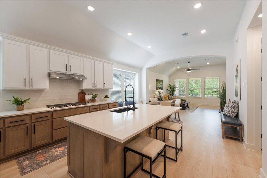 An open concept design seamlessly connects the kitchen with a sun-drenched living area, perfect for entertaining. An open concept design seamlessly connects the kitchen with a sun-drenched living area, perfect for entertaining.