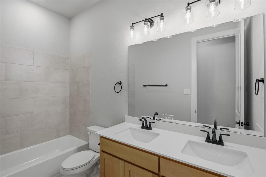 Bathroom with double vanity and shower / bathtub combination