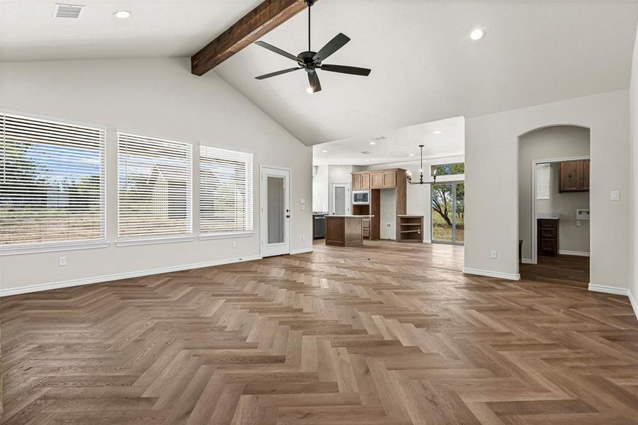 Unfurnished living room with recessed lighting, beam ceiling, high vaulted ceiling, and a ceiling fan