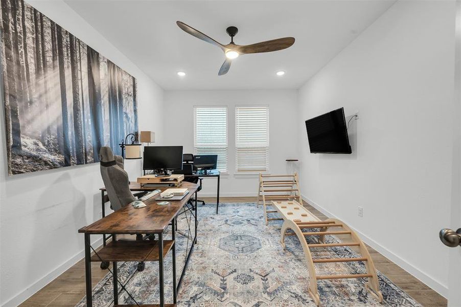 Home office featuring hardwood / wood-style flooring and ceiling fan