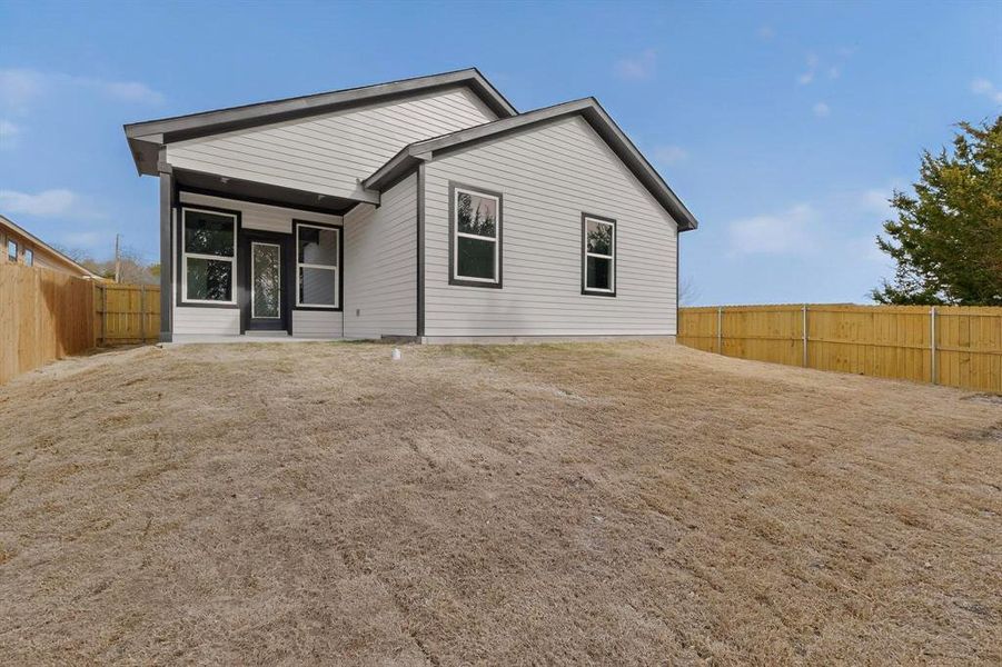 Rear view of house with a fenced backyard and a patio Rear view of house with a fenced backyard and a patio