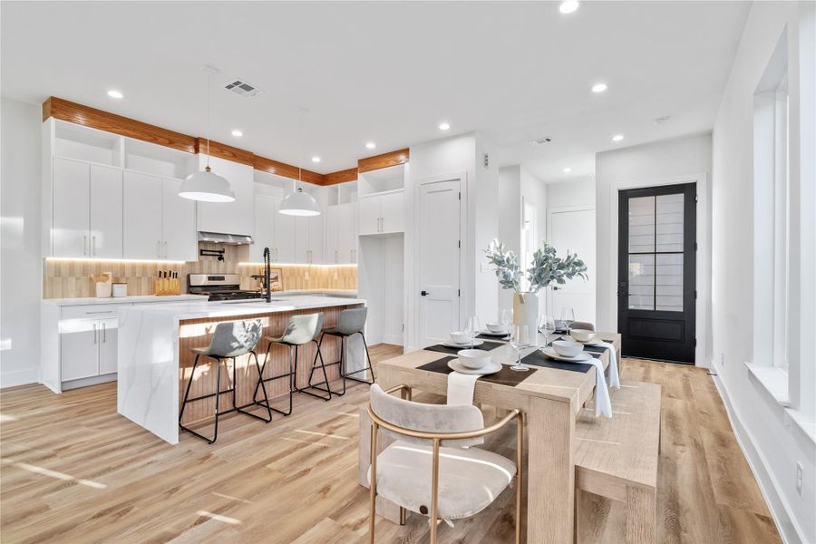 A bright, airy living room featuring high ceilings, large windows for natural light, and elegant lighting. A bright, airy living room featuring high ceilings, large windows for natural light, and elegant lighting.