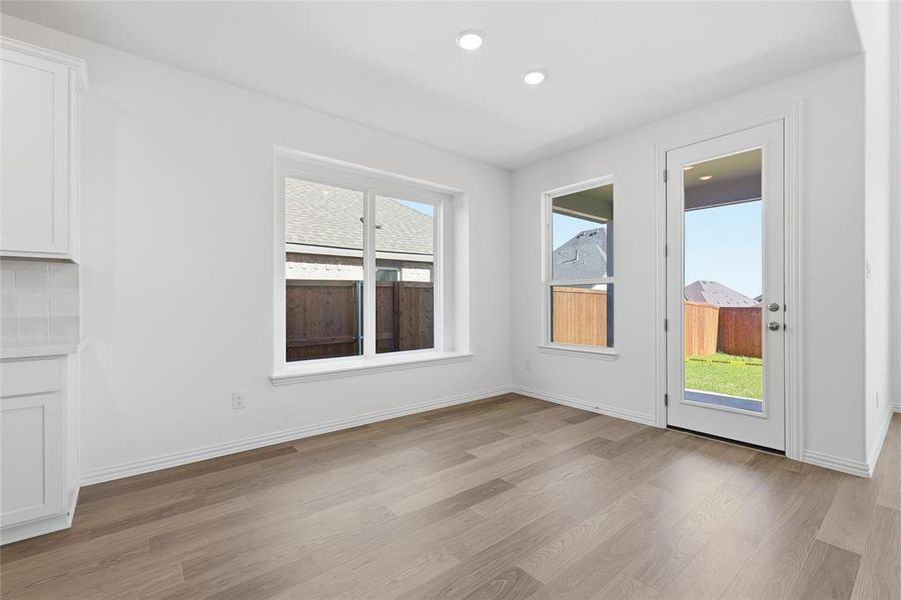 Unfurnished dining area featuring dark wood-style flooring and recessed lighting